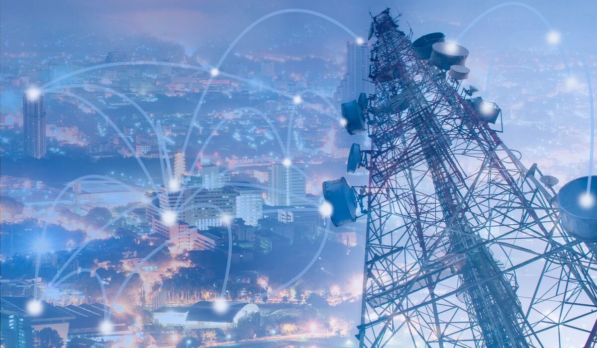 Engineers performing telecom tower installation during network deployment